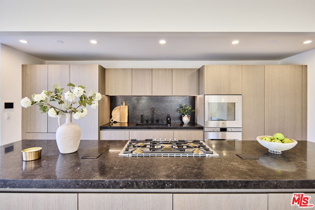 23515 Malibu Colony Road Malibu, CA 90265 - Photo 7 of 22 a kitchen with a stove and a granite counter top