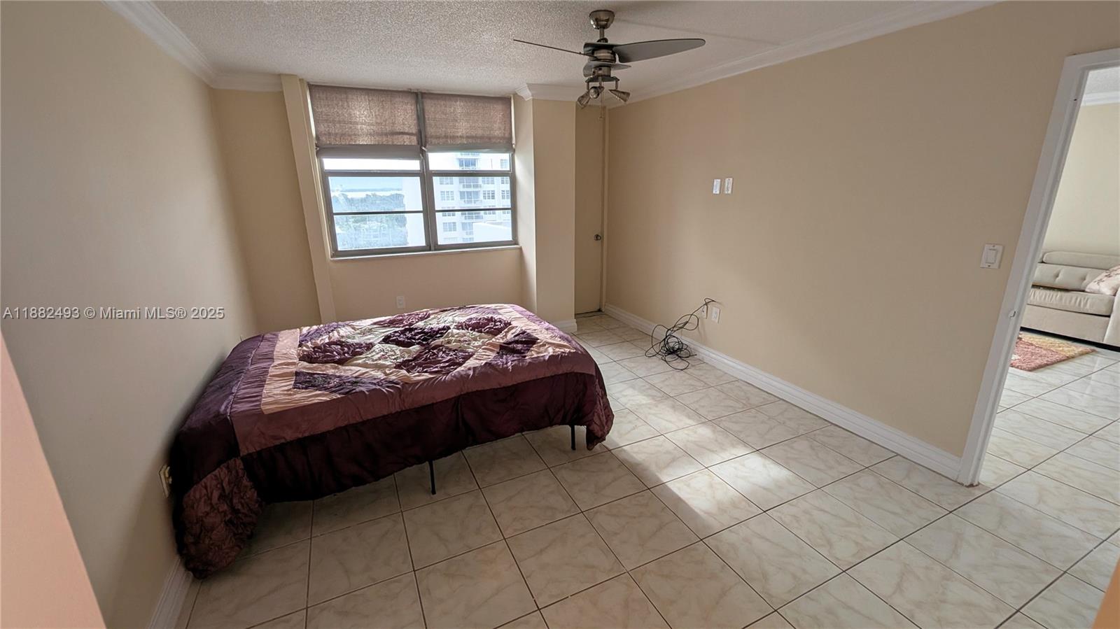 5701 Collins Avenue, Unit 1105 Miami Beach, FL 33140 - Photo 14 of 26 a bedroom with a bed and a window