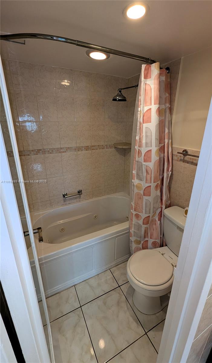 5701 Collins Avenue, Unit 1105 Miami Beach, FL 33140 - Photo 16 of 26 a bathroom with a toilet and a shower