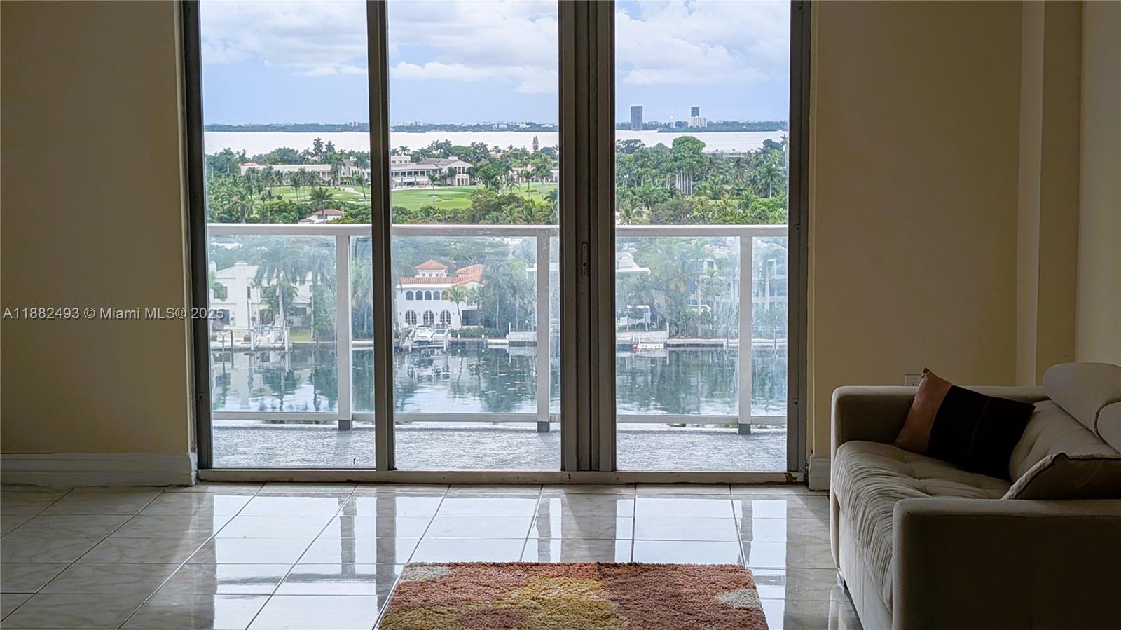 5701 Collins Avenue, Unit 1105 Miami Beach, FL 33140 - Photo 2 of 26 a living room with furniture and a floor to ceiling window