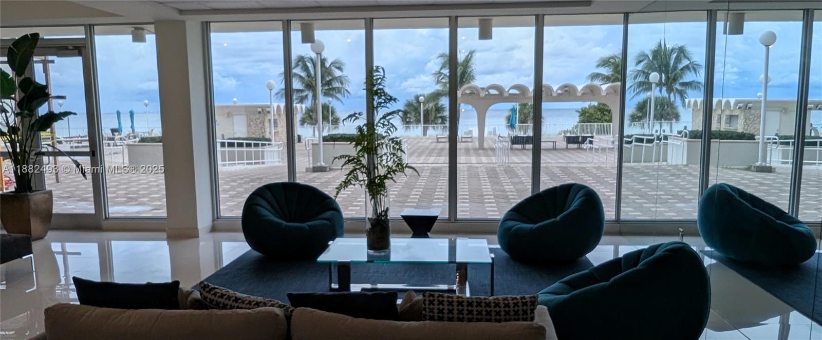 5701 Collins Avenue, Unit 1105 Miami Beach, FL 33140 - Photo 23 of 26 a living room with furniture and a fireplace