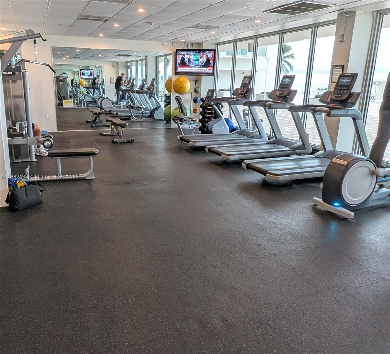 5701 Collins Avenue, Unit 1105 Miami Beach, FL 33140 - Photo 24 of 26 a view of a room with gym equipment