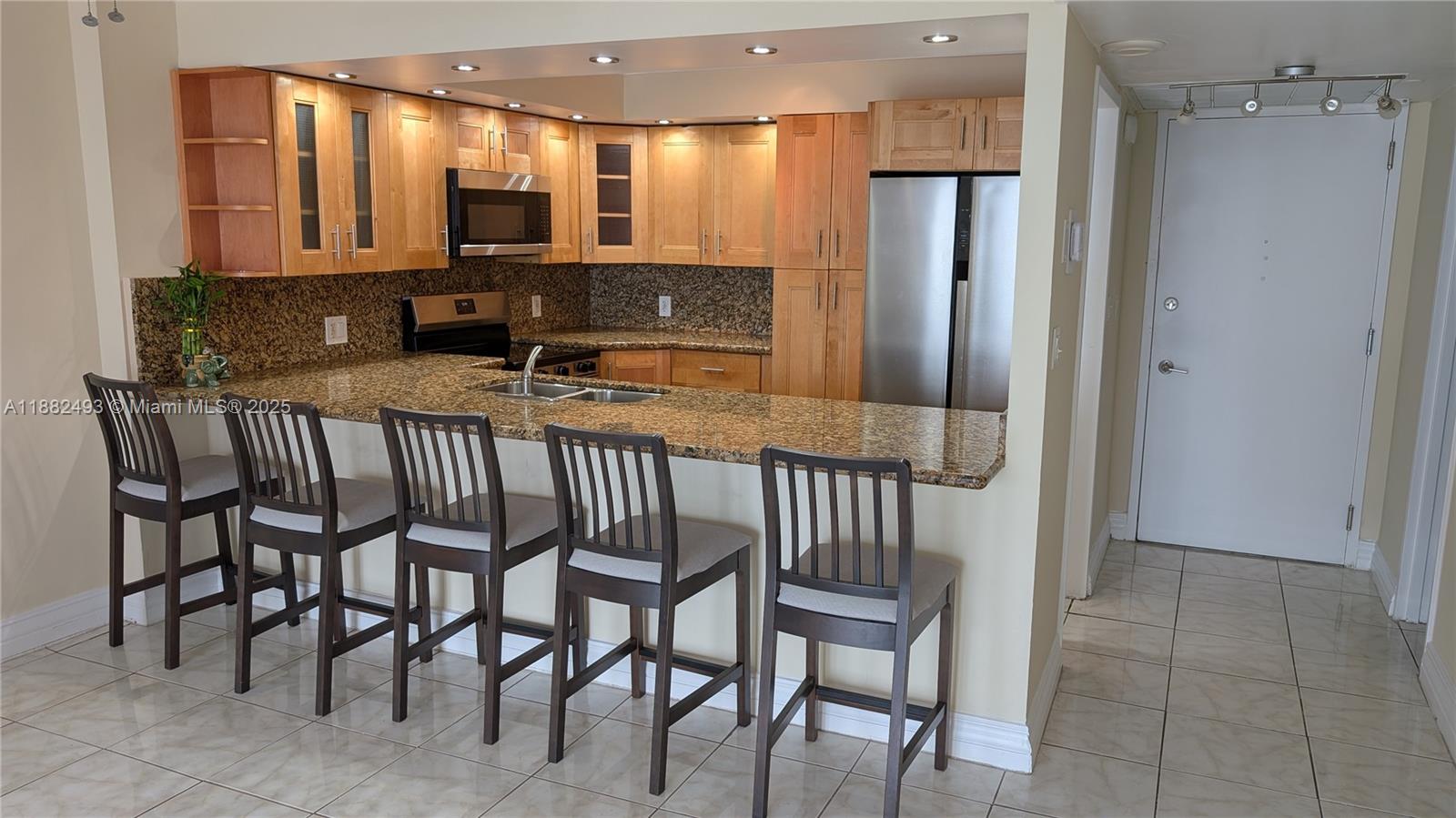 5701 Collins Avenue, Unit 1105 Miami Beach, FL 33140 - Photo 9 of 26 a view of a hallway with seating area and furniture