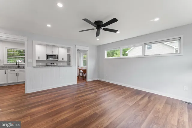 a view of a kitchen with a sink cabinets and wooden floor