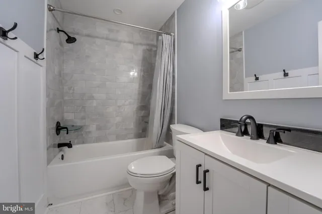 a bathroom with a sink a toilet and a bathtub