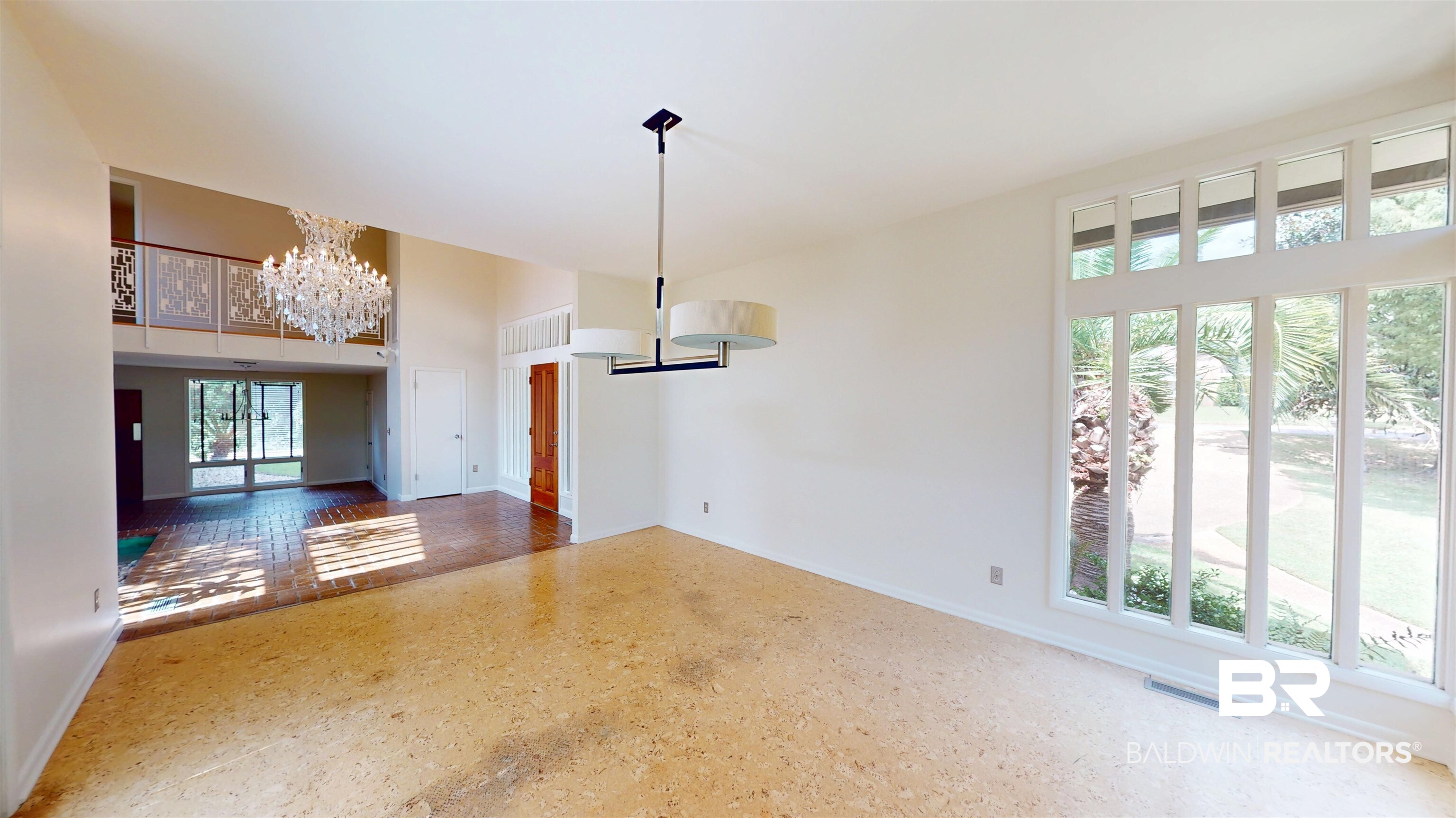 15 Spring Bank Road Mobile, AL 36608 - Photo 13 of 58 Unfurnished dining area featuring a chandelier, a towering ceiling, and french doors