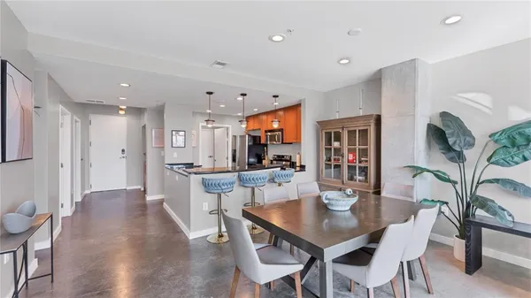 a dining room with furniture and wooden floor