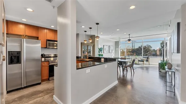 a kitchen with a table chairs refrigerator and microwave