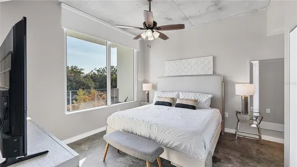 a bedroom with a bed and a window