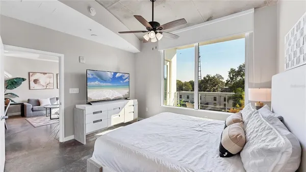 a bedroom with a bed and a flat screen tv