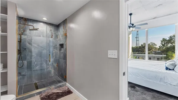 a view of bathroom with a shower and a sink