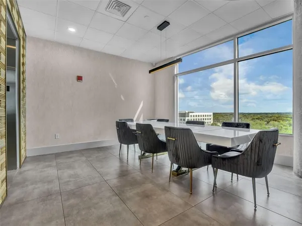 a view of a dining room with furniture window and outside view