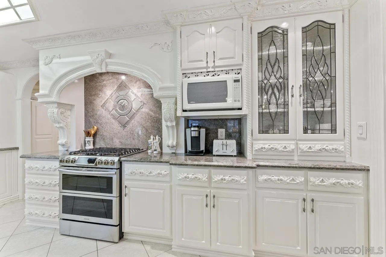 1728 Rancho Judith Alpine, CA 91901 - Photo 20 of 68 a kitchen with granite countertop white cabinets and appliances