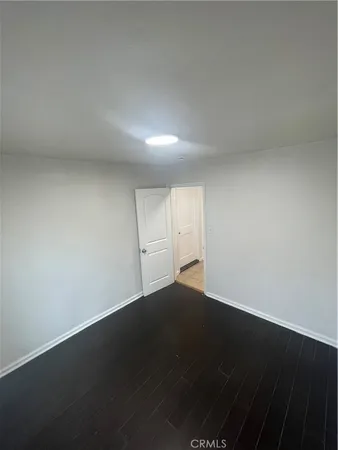 an empty room with wooden floor