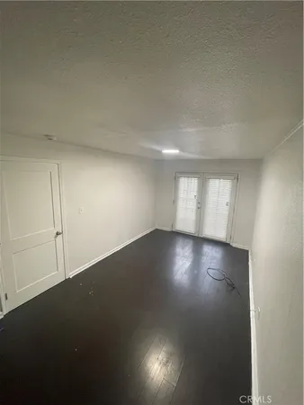 a view of room and hall with wooden floor