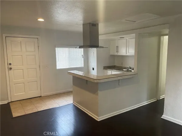 a kitchen with kitchen island a sink appliances and cabinets