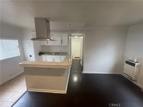 a view of kitchen and sink with wooden floor