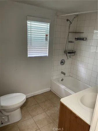 a bathroom with a sink a toilet and bathtub