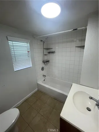 a bathroom with a sink a toilet and bathtub