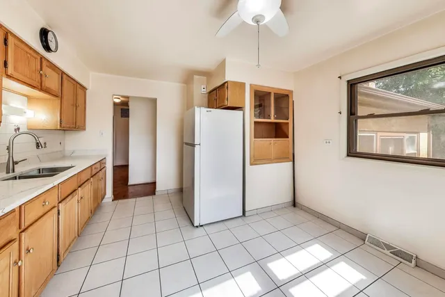 a kitchen with stainless steel appliances granite countertop a refrigerator and a sink