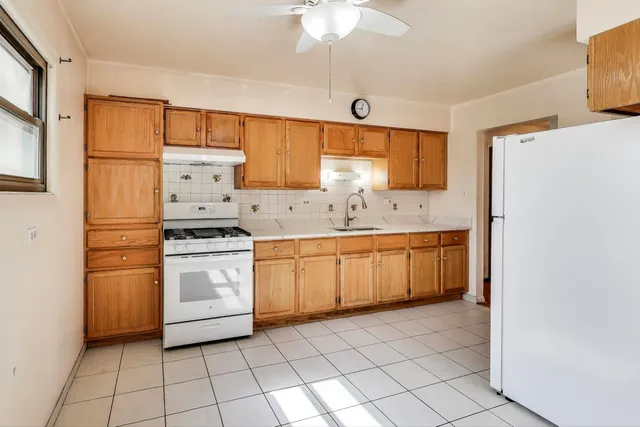 a kitchen with a stove a sink and a refrigerator