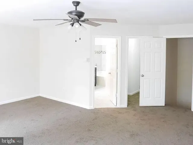 a view of a livingroom with a ceiling fan and a window