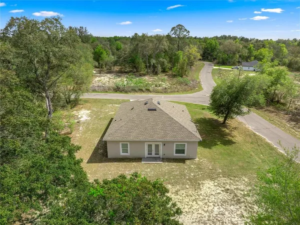 an aerial view of a house with a yard