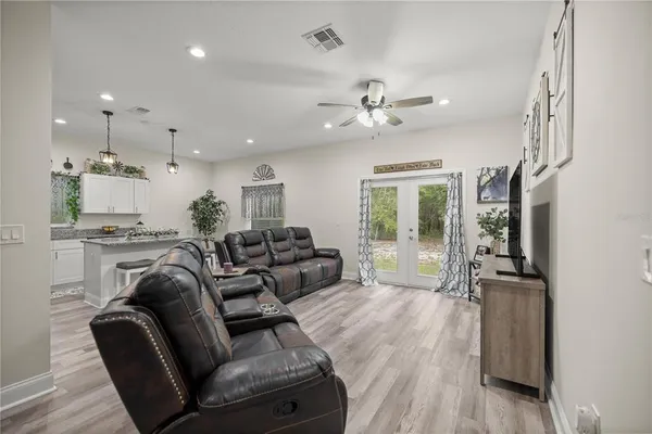 a living room with furniture and a chandelier