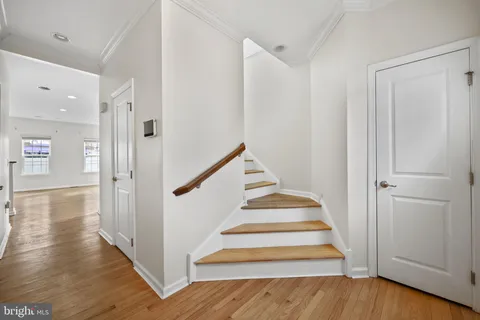 a view of an entryway with wooden floor and staircase