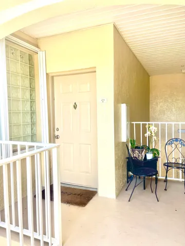 a view of a balcony with chair and white walls