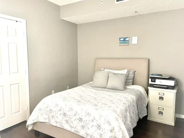 a large bed sitting in a bedroom next to a window