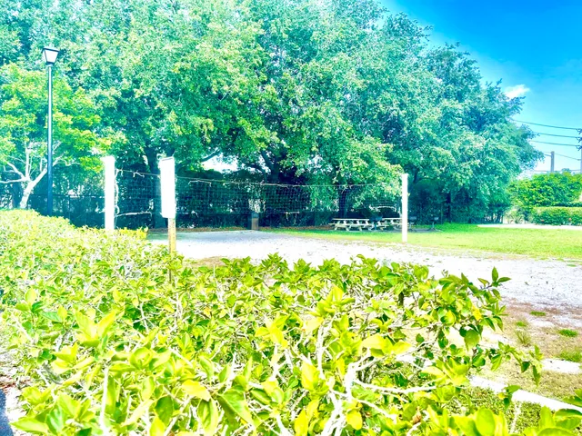 a backyard of a house with lots of green space and fountain