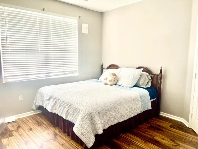 a bedroom with a bed and a window