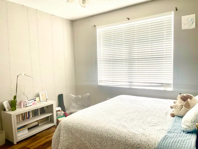 a bedroom with a bed and a window