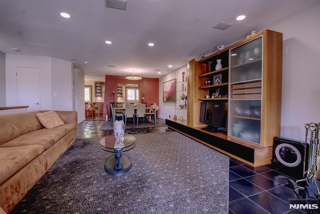 300 Gorge Road, Unit 18 Cliffside Park, NJ 07010 - Photo 12 of 38 a living room with furniture a flat screen tv and rug