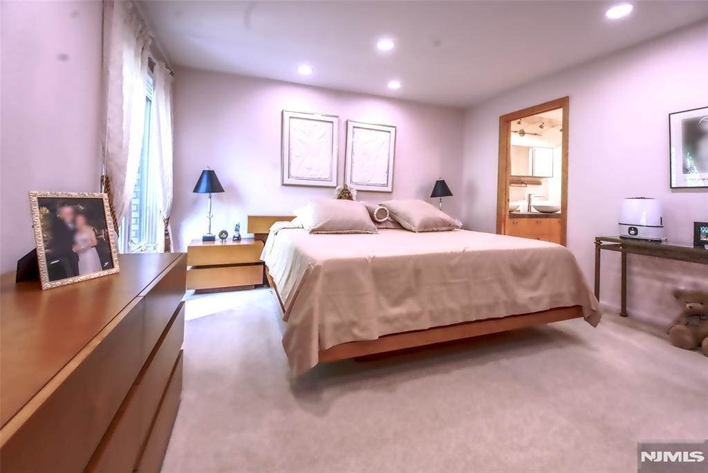 300 Gorge Road, Unit 18 Cliffside Park, NJ 07010 - Photo 20 of 38 a bedroom with a bed couch and windows