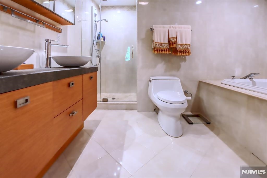 300 Gorge Road, Unit 18 Cliffside Park, NJ 07010 - Photo 23 of 38 a bathroom with a sink a toilet and mirror