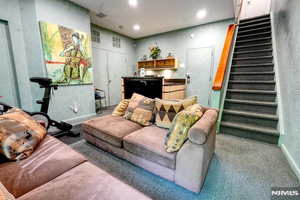 300 Gorge Road, Unit 18 Cliffside Park, NJ 07010 - Photo 27 of 38 a living room with furniture and a flat screen tv