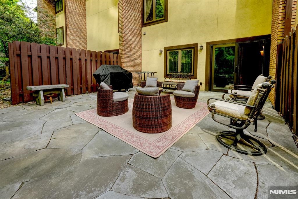 300 Gorge Road, Unit 18 Cliffside Park, NJ 07010 - Photo 32 of 38 a view of a patio with dining table and chairs