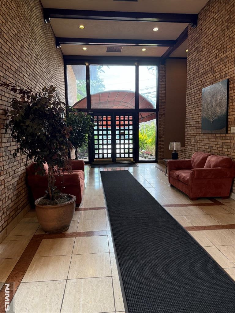 300 Gorge Road, Unit 18 Cliffside Park, NJ 07010 - Photo 5 of 38 a living room with a couch and a potted plant