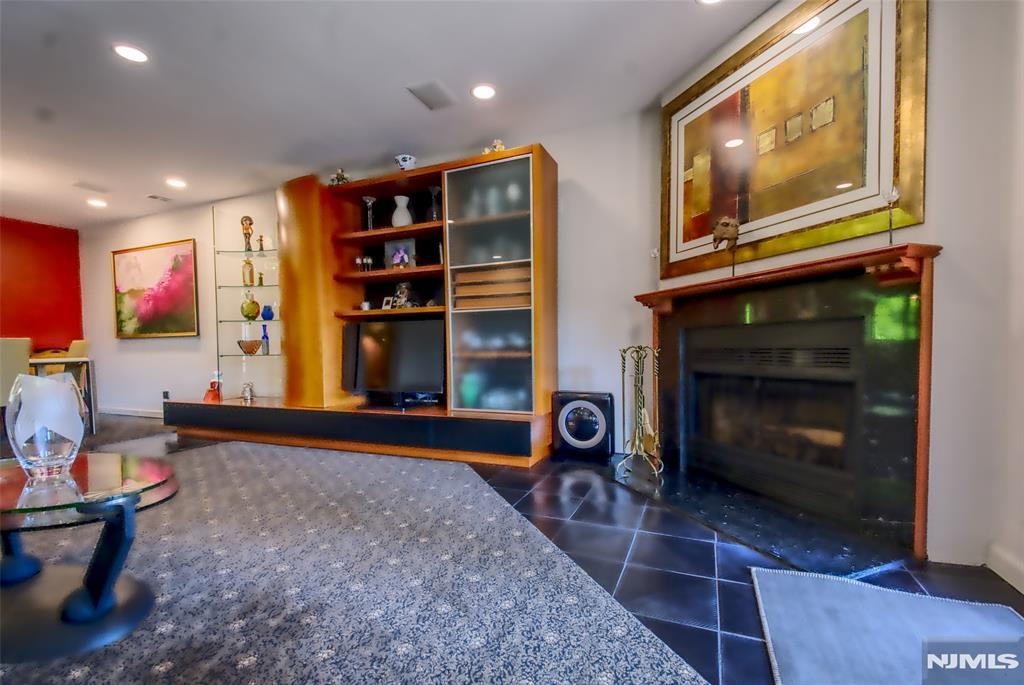 300 Gorge Road, Unit 18 Cliffside Park, NJ 07010 - Photo 10 of 38 a living room with furniture a flat screen tv and a fireplace