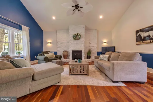 a living room with fireplace furniture and a fireplace