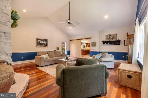 a living room with furniture ceiling fan and a rug