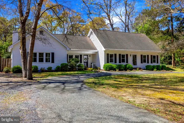 a front view of a house with swimming pool and porch