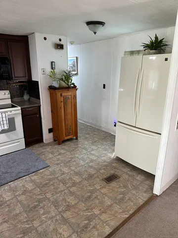 a kitchen with stainless steel appliances granite countertop a refrigerator and a stove