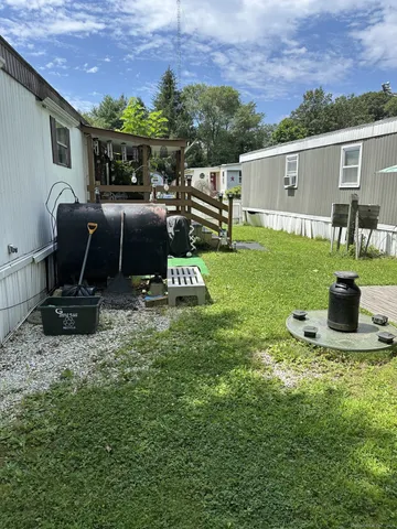 a view of backyard with seating area and green space