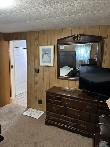 a living room with furniture and a mirror