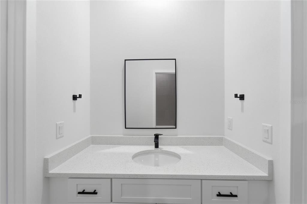 2600 Southwest 146th Pl Road Ocala, FL 34473 - Photo 17 of 40 a bathroom with a sink and a mirror
