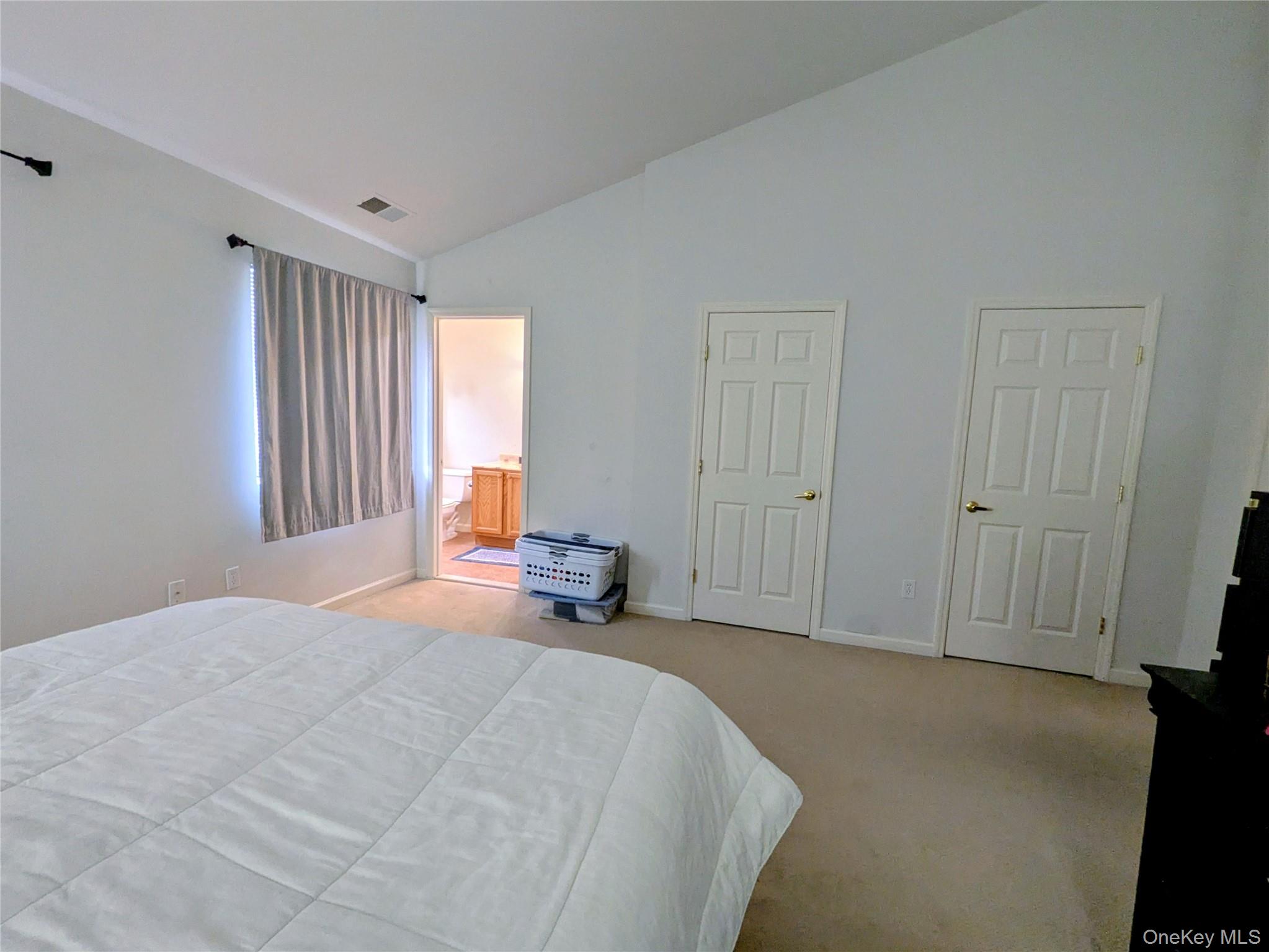 1206 Eagles Ridge Road Brewster, NY 10509 - Photo 17 of 29 Carpeted bedroom featuring ensuite bathroom and high vaulted ceiling