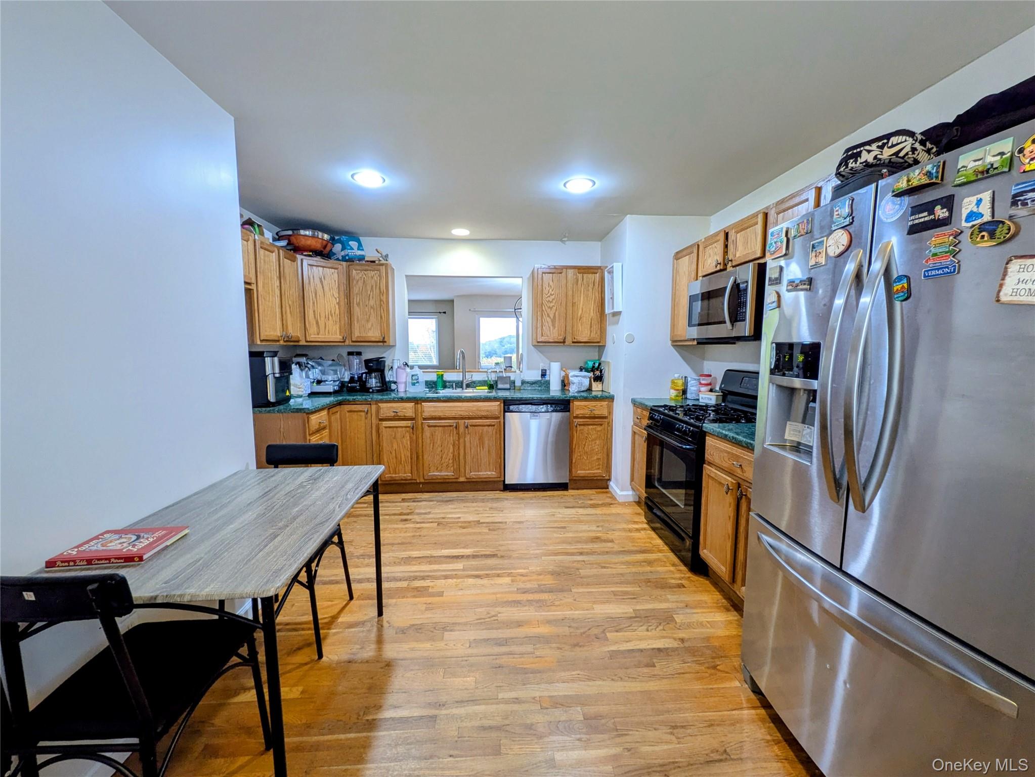1206 Eagles Ridge Road Brewster, NY 10509 - Photo 3 of 29 Kitchen featuring stainless steel appliances, light wood-style flooring, brown cabinets, and recessed lighting